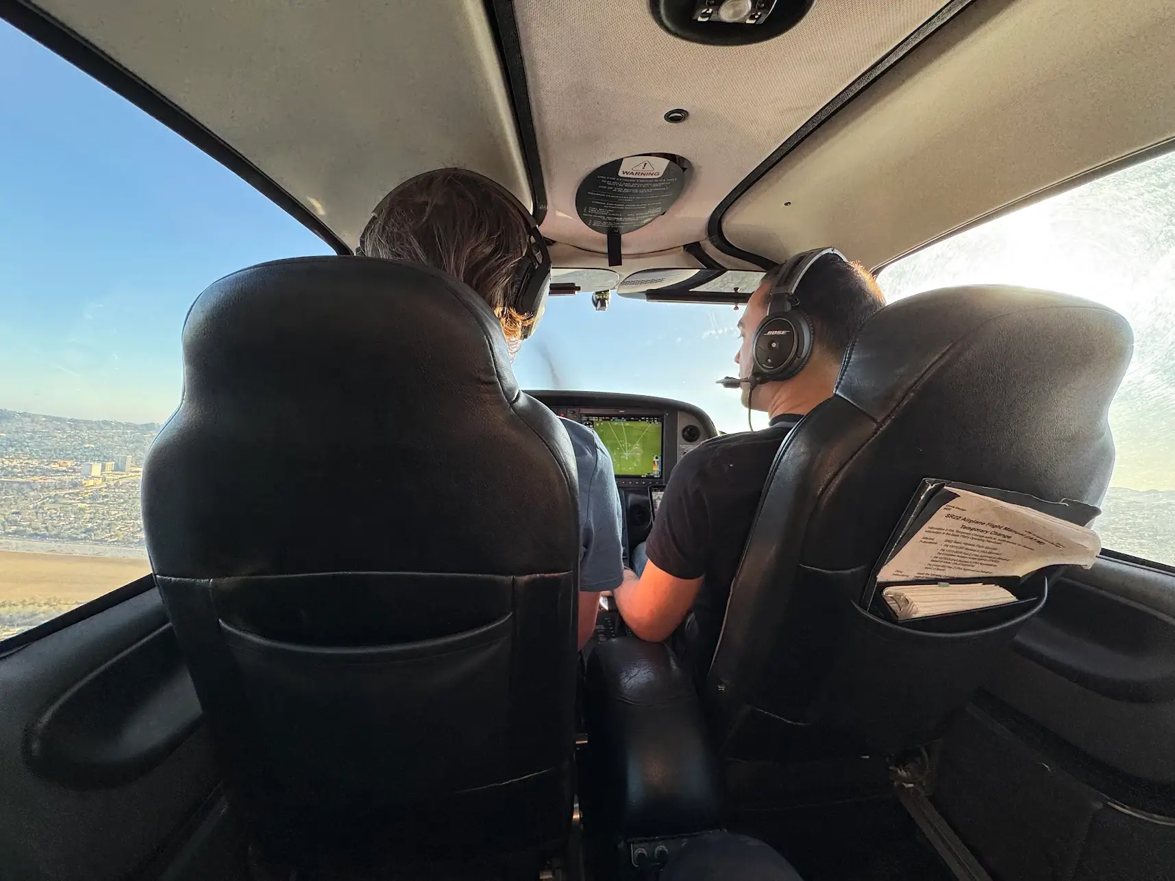Students at Essence Flight School in Van Nuys Airport learning to fly in a Piper Archer cockpit